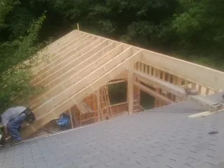 Framing a new roof addition that ties into an existing shingle roof in Sauk City